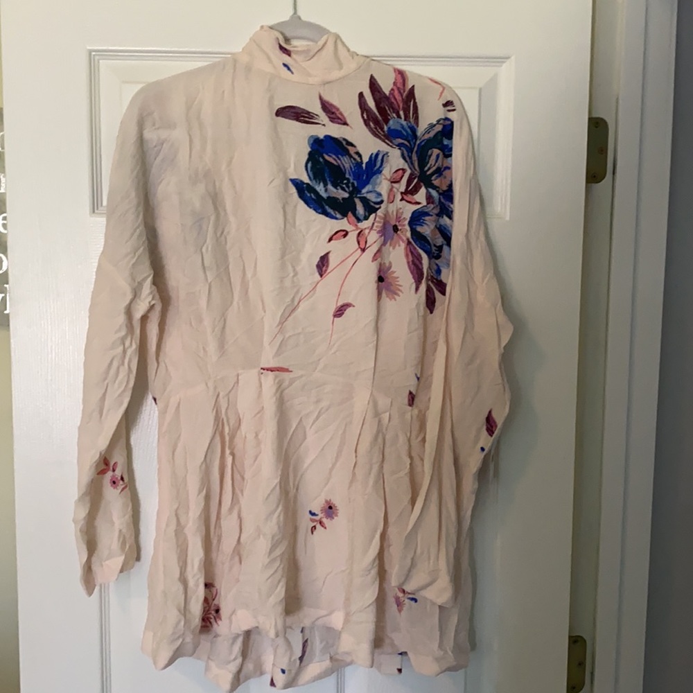 Free People Women’s shirt.  NWT.  Light pink with floral design.  Size medium.